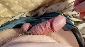 Close up of penis vulnerable to pings of urethral sounding rod